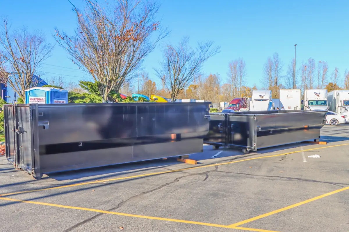 Professional dumpster rental service with roll-off container on residential driveway in Lacombe